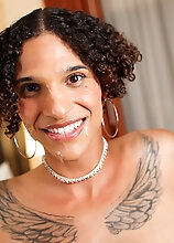 Watch Deja Beige as she shows off her sexy tattooed body, spreads her nice ass and strokes her long cock until she cums in her own mouth
