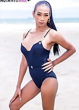 Ladyboy Oil starts to take off her jeans and shows her body. Under that black bodysuit have a nice hard cock waiting for you to see and feel it